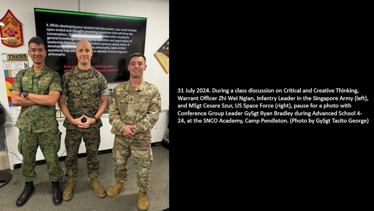 31 July 2024. During a class discussion on Critical and Creative Thinking, Warrant Officer Zhi Wei Ngian, Infantry Leader in the Singapore Army (left), and MSgt Cesare Szur, US Space Force (right), pause for a photo with Conference Group Leader GySgt Ryan Bradley during Advanced School 4-24, at the SNCO Academy, Camp Pendleton. (Photo by GySgt Tacito George)