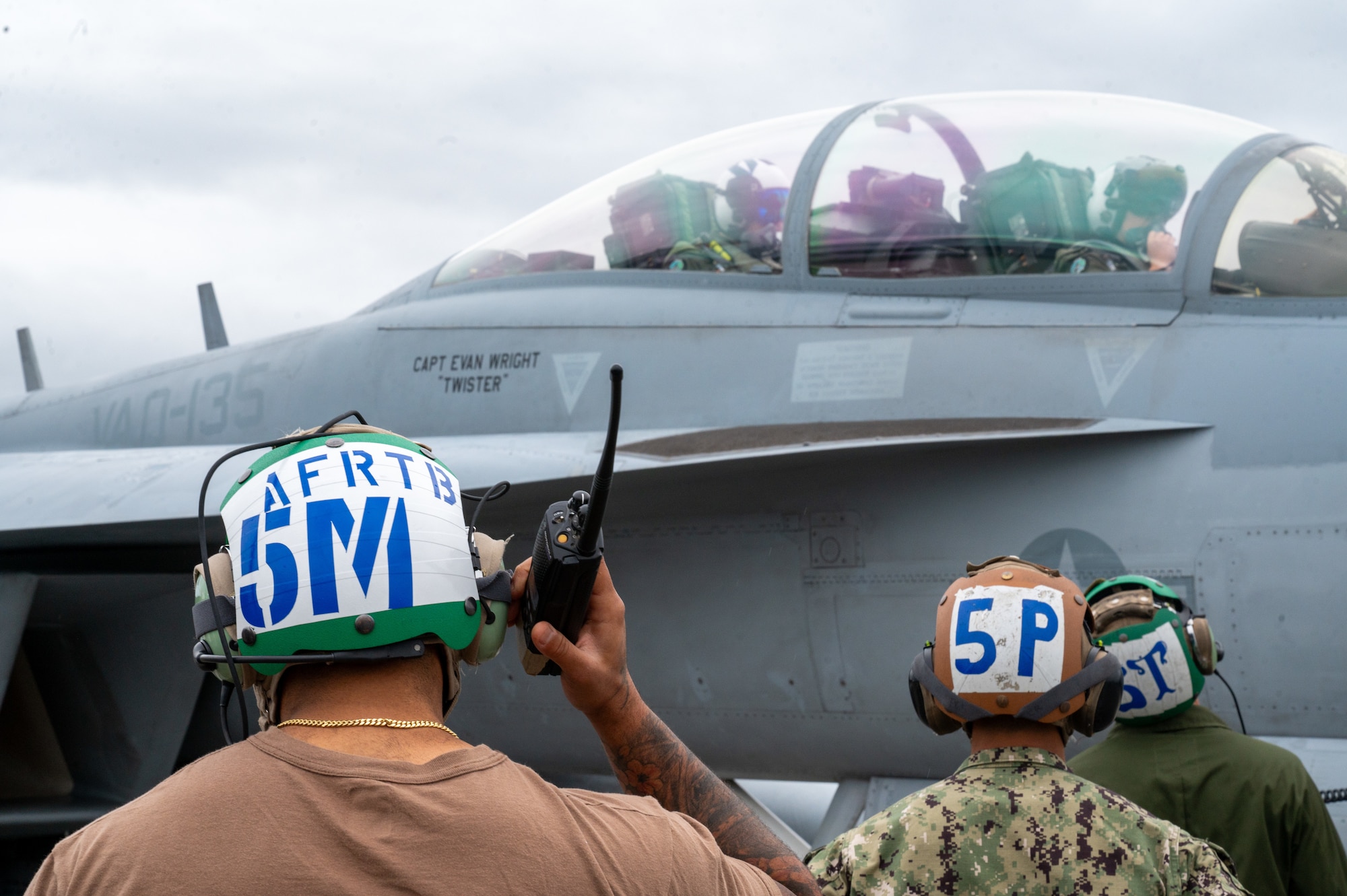 A U.S. Navy maintainer, assigned to the Electronic Attack Squadron 135 (VAQ-135) “Black Ravens,” prepares an EA-18G Growler for take-off during Red Flag-Alaska 24-3 at Eielson Air Force Base, Alaska.