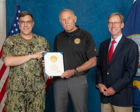 (left) Capt. David Back, Naval Surface Warfare Center Panama City Division commanding officer and Dr. Peter Adair, NSWC PCD technical director, recognize (center) Tim McTrusty, NSWC PCD engineer, for 50 years of federal service to the U.S. Navy, April 16.  McTrusty also was enlisted and served for 34 years in active duty and reserve status retiring from the Navy as a special operations master chief. (U.S. Navy photo by Eddie Green)