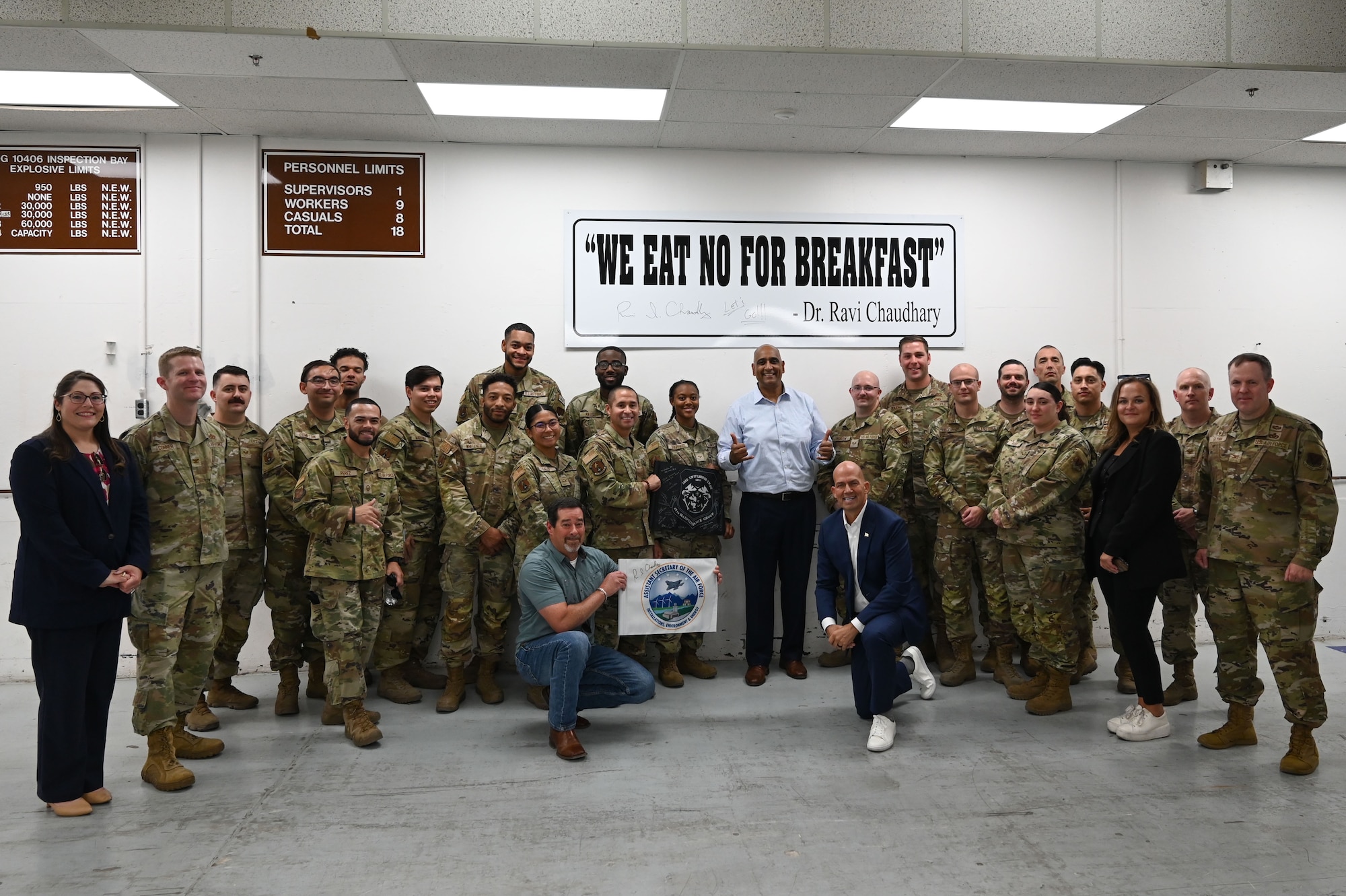 Dr. Ravi Chaudhary, Assistant Secretary of the Air Force for Energy, Installations, and Environment (SAF/IE), poses for a photo with Airmen assigned to the 57th Munitions Squadron