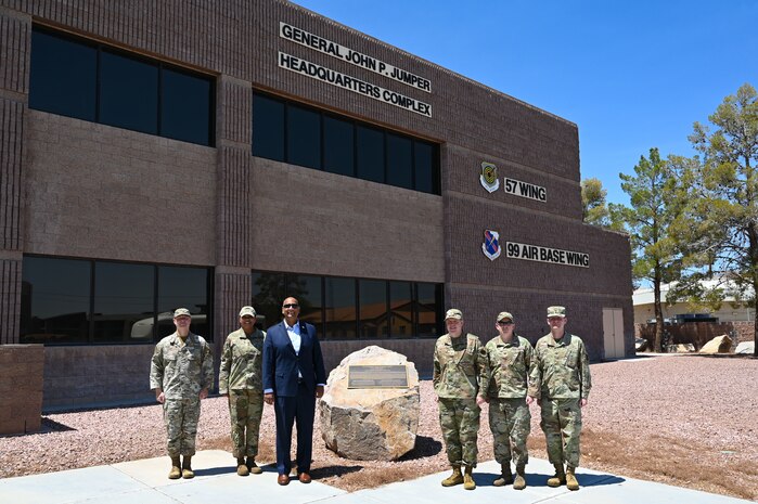 Dr. Ravi Chaudhary, Assistant Secretary of the Air Force for Energy, Installations, and Environment (SAF/IE), poses for a photo with the 57th Wing and 99th Air Base Wing leadership