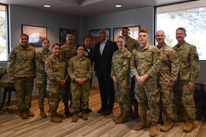 Dr. Ravi Chaudhary, Assistant Secretary of the Air Force for Energy, Installations, and Environment (SAF/IE), poses for a photo with Airmen assigned to Nellis
