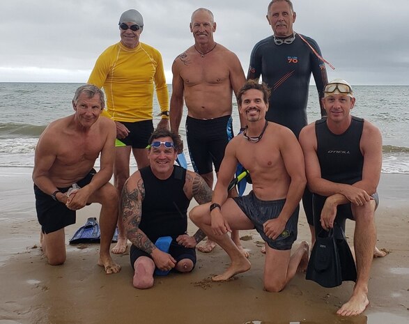 Navy SEAL swimmer group at ‘Dog White’ sector of Omaha Beach, August 2022. (top right) Tim McTrusty, Naval Surface Warfare Center Panama City Division engineer, was one of seven SEALs who completed the 3-mile, 65 degrees Fahrenheit swim to commemorate the Navy SEAL forefathers clearing of the beaches at Omaha Beach during the D-Day invasion on June 6, 1944. (courtesy photo)