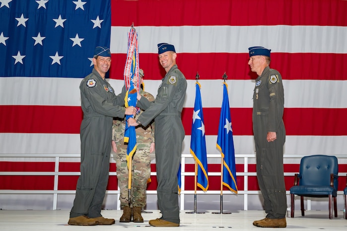 U.S. Air Force Gen. Ken Wilsbach, commander of the Air Combat Command, passes the guidon to Maj. Gen. Christopher Niemi, incoming commander of the U.S. Air Force Warfare Center (USAFWC)