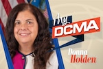A woman wearing a pink and white blouse, smiling.
My DCMA, Donna Holden