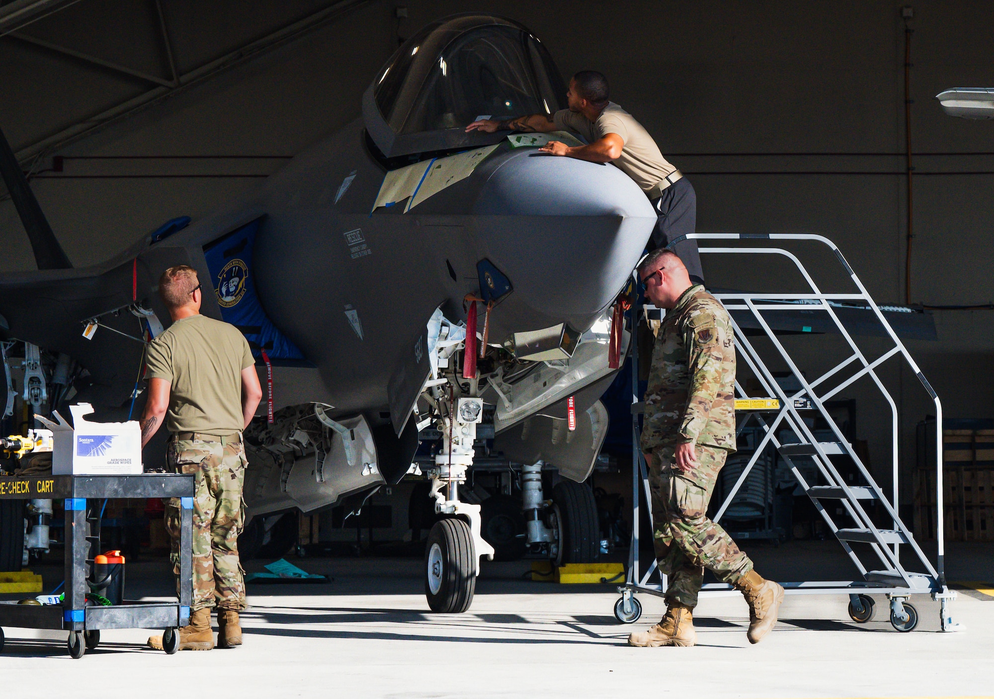 Airmen work on an aircraft