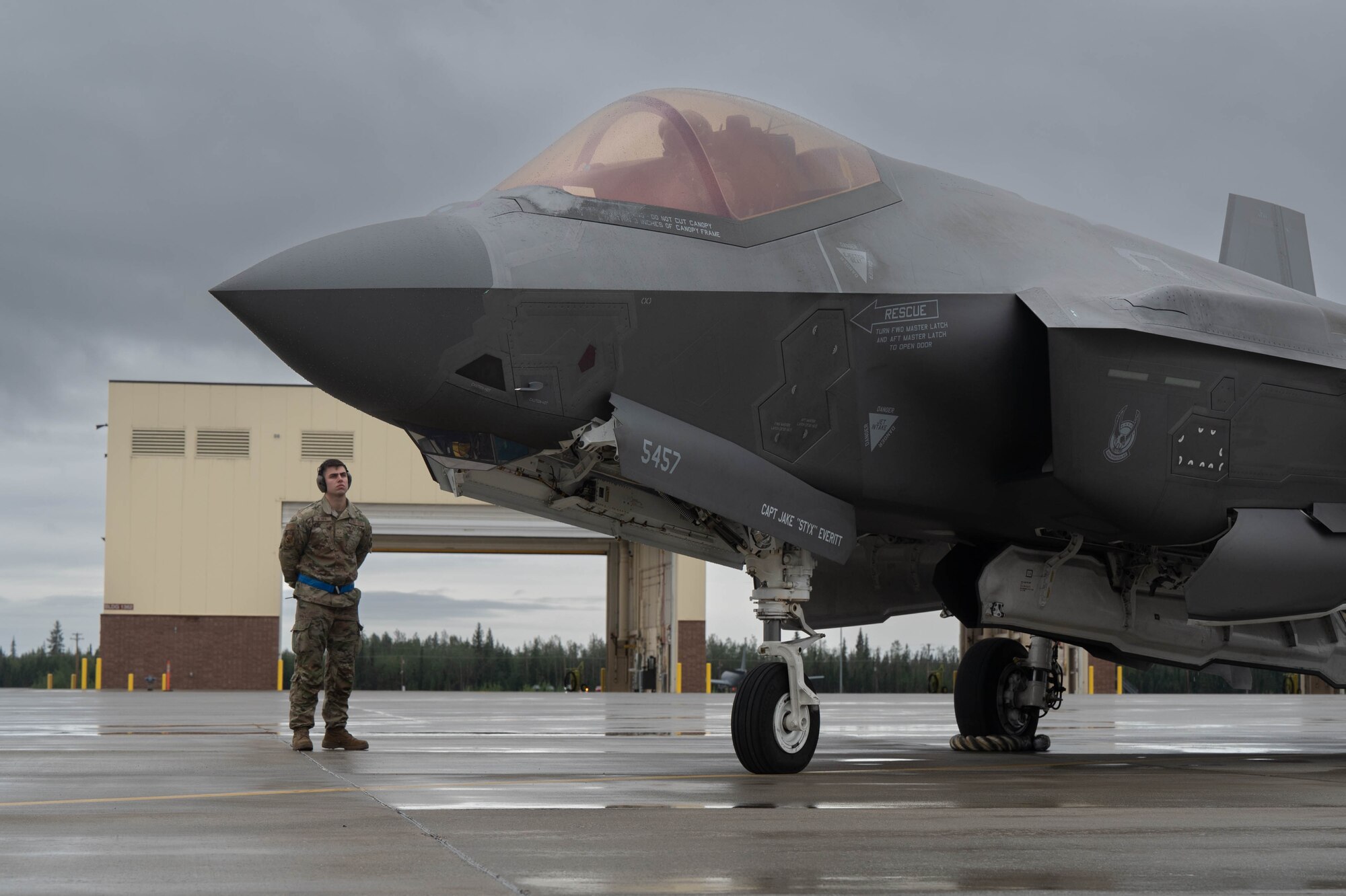 U.S. Air Force Senior Airman Noah Weiher, 355th Fighter Generation Squadron weapons specialist, stands by before an F-35A Lightning II taxis on the runway at Eielson Air Force Base, Alaska, Aug. 22, 2024.