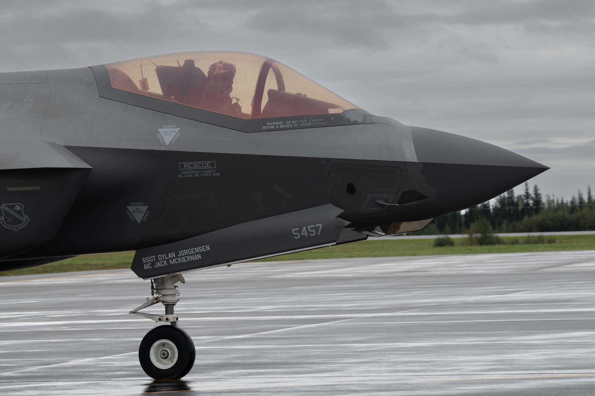 U.S. Air Force Capt. Analise “Hype” Howard, 355th Fighter Squadron pilot, gestures the squadron’s sign “Talons Out” during Red Flag-Alaska 24-3 at Eielson Air Force Base, Alaska, Aug. 22, 2024.