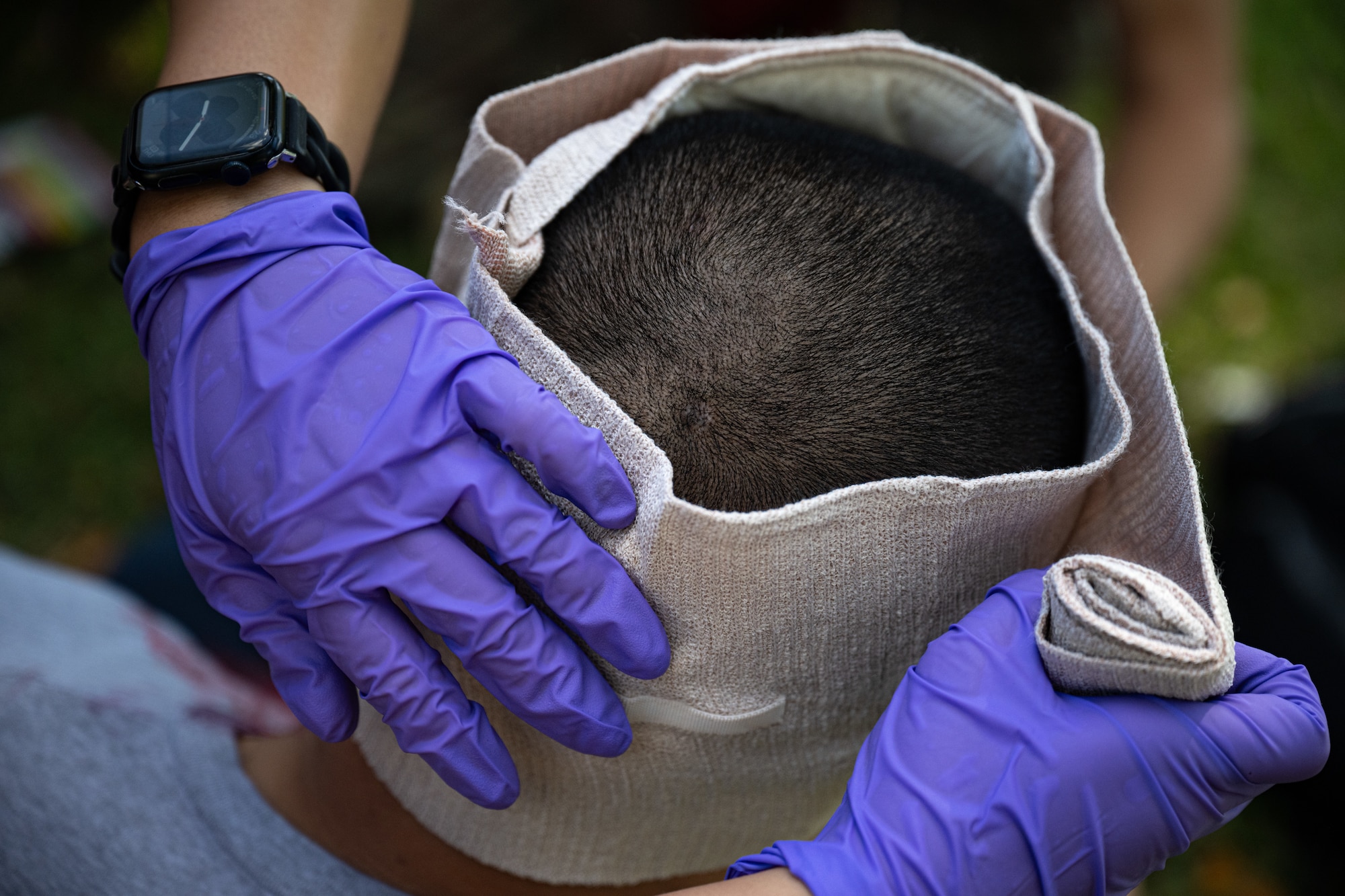 Airmen treat a simulated patient during an exercise.