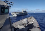 PHILIPPINE SEA (Aug. 18, 2024) – The Arleigh Burke-class guided-missile destroyer USS Dewey (DDG 105) approaches the Italian Navy aircraft carrier ITS Cavour (CVH 550), left, while the Carlo Bergamini-class frigate ITS Alpino (F 594) steams ahead during a simulated underway replenishment in the Philippine Sea, Aug. 18, 2024. Dewey is forward-deployed and assigned to Destroyer Squadron (DESRON) 15, the Navy’s largest DESRON and the U.S. 7th Fleet’s principal surface force. (U.S. Navy photo by Mass Communication Specialist 1st Class Greg Johnson)