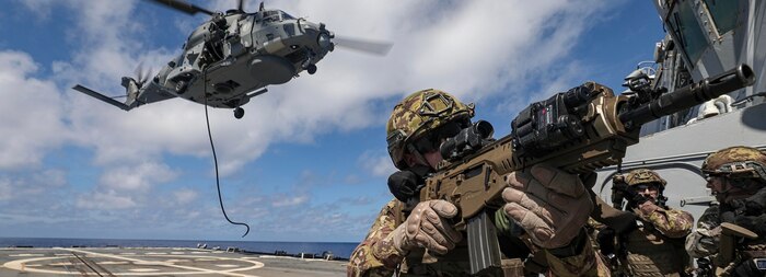 Italian Navy Subchief 3rd Class Simone Matteo boards the U.S. Navy Arleigh Burke-class guided-missile destroyer USS Dewey (DDG 105) during a visit, board, search and seizure drill in the Philippine Sea, Aug. 20, 2024.