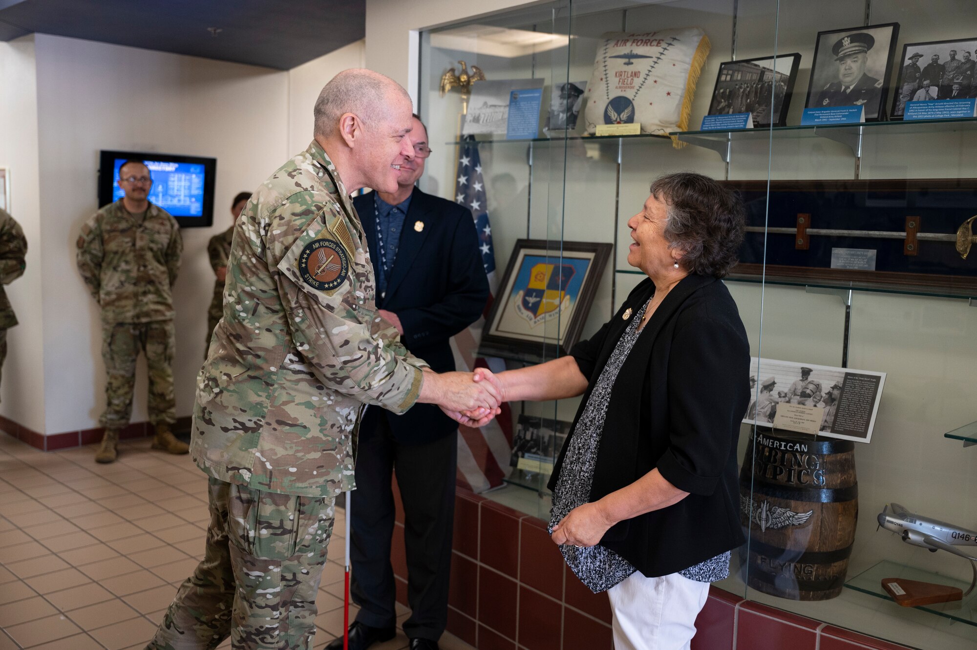 A man shakes a woman's hand.