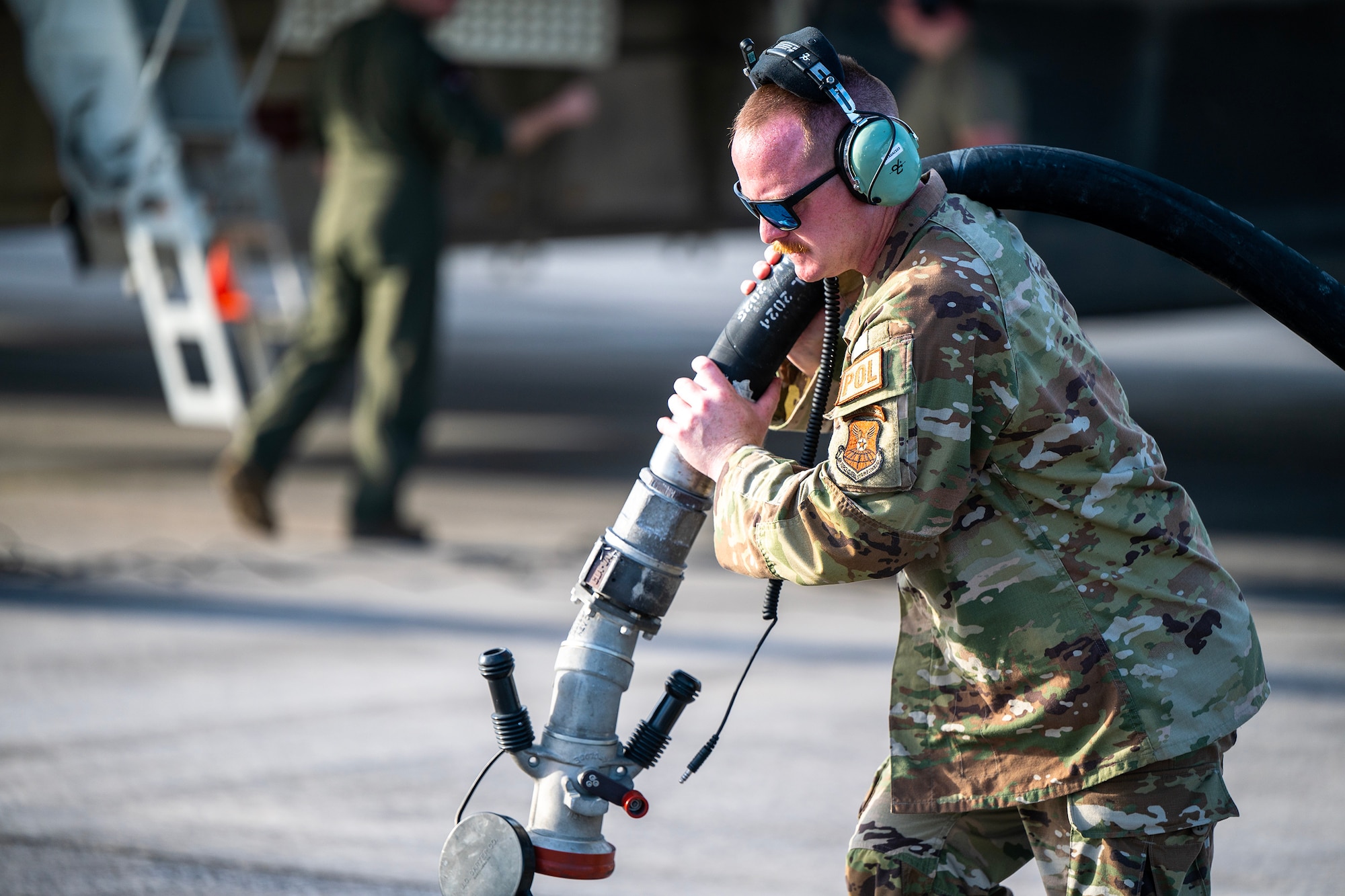 U.S. Air Force Tech Sgt. Daniel Lemons, a fuels personnel assigned to the 110th Expeditionary Bomb Squadron pulls out a fuel hose during a hot pit refuel on a B-2 Spirit stealth bomber during a Bomber Task Force mission at Diego Garcia, British Indian Ocean Territory, Aug. 21, 2024. BTF missions enhance readiness, to include joint and multi-lateral, to respond to any potential crisis or challenge in the Indo-Pacific. (U.S. Air National Guard photo by Staff Sgt. Whitney Erhart)