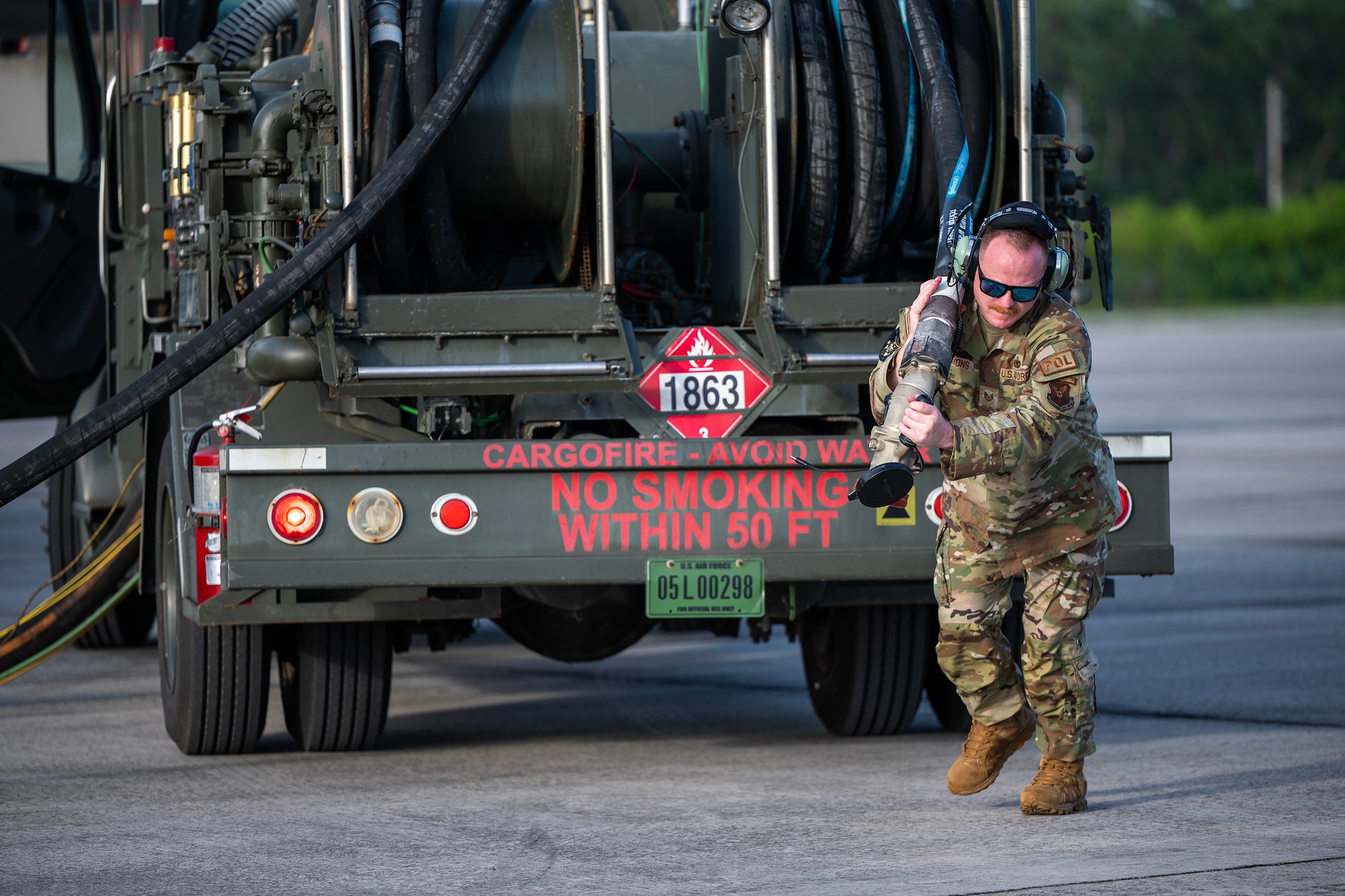 U.S. Air Force Tech Sgt. Daniel Lemons, a fuels personnel assigned to the 110th Expeditionary Bomb Squadron pulls out a fuel hose during a hot pit refuel on a B-2 Spirit stealth bomber during a Bomber Task Force mission at Diego Garcia, British Indian Ocean Territory, Aug. 21, 2024. BTF missions enhance readiness, to include joint and multi-lateral, to respond to any potential crisis or challenge in the Indo-Pacific. (U.S. Air National Guard photo by Staff Sgt. Whitney Erhart)