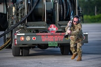 U.S. Air Force Tech Sgt. Daniel Lemons, a fuels personnel assigned to the 110th Expeditionary Bomb Squadron pulls out a fuel hose during a hot pit refuel on a B-2 Spirit stealth bomber during a Bomber Task Force mission at Diego Garcia, British Indian Ocean Territory, Aug. 21, 2024. BTF missions enhance readiness, to include joint and multi-lateral, to respond to any potential crisis or challenge in the Indo-Pacific. (U.S. Air National Guard photo by Staff Sgt. Whitney Erhart)