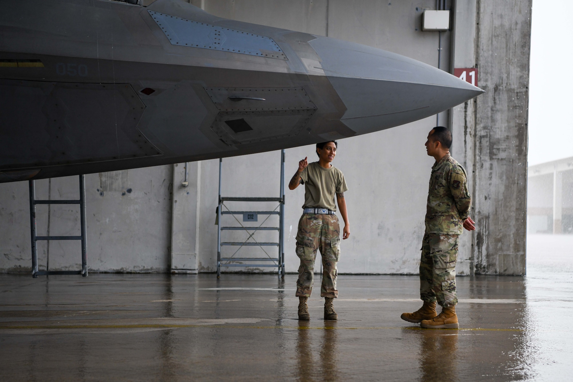 Two Airmen conduct preflight inspections.