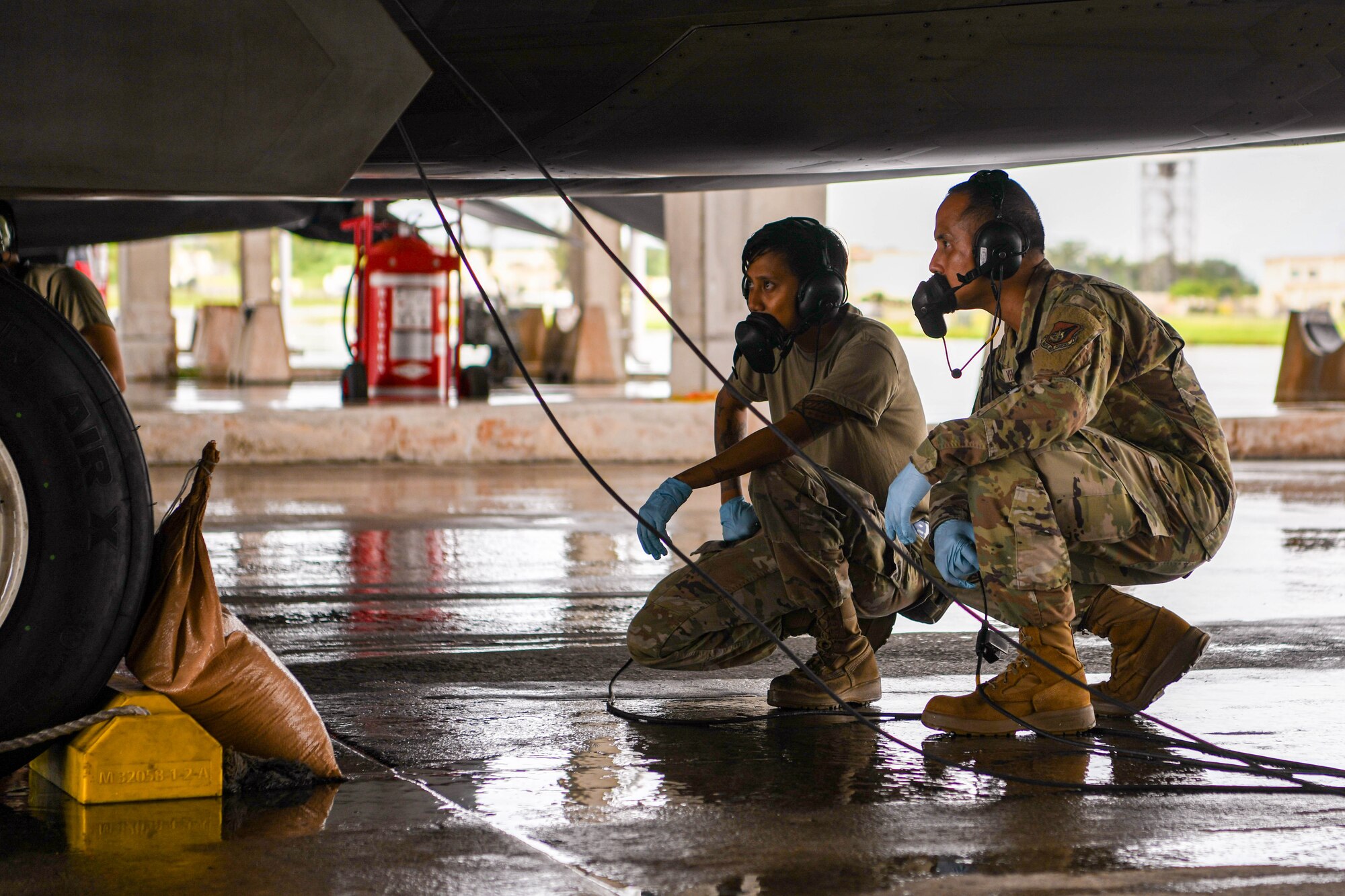 Two Airmen conduct preflight inspections.