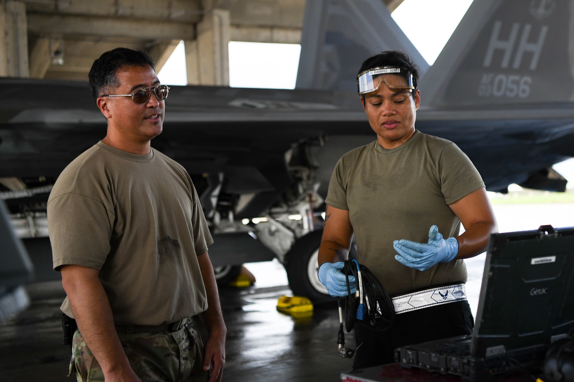 A Crew Chief explains flight line operations to a cyber Airman.