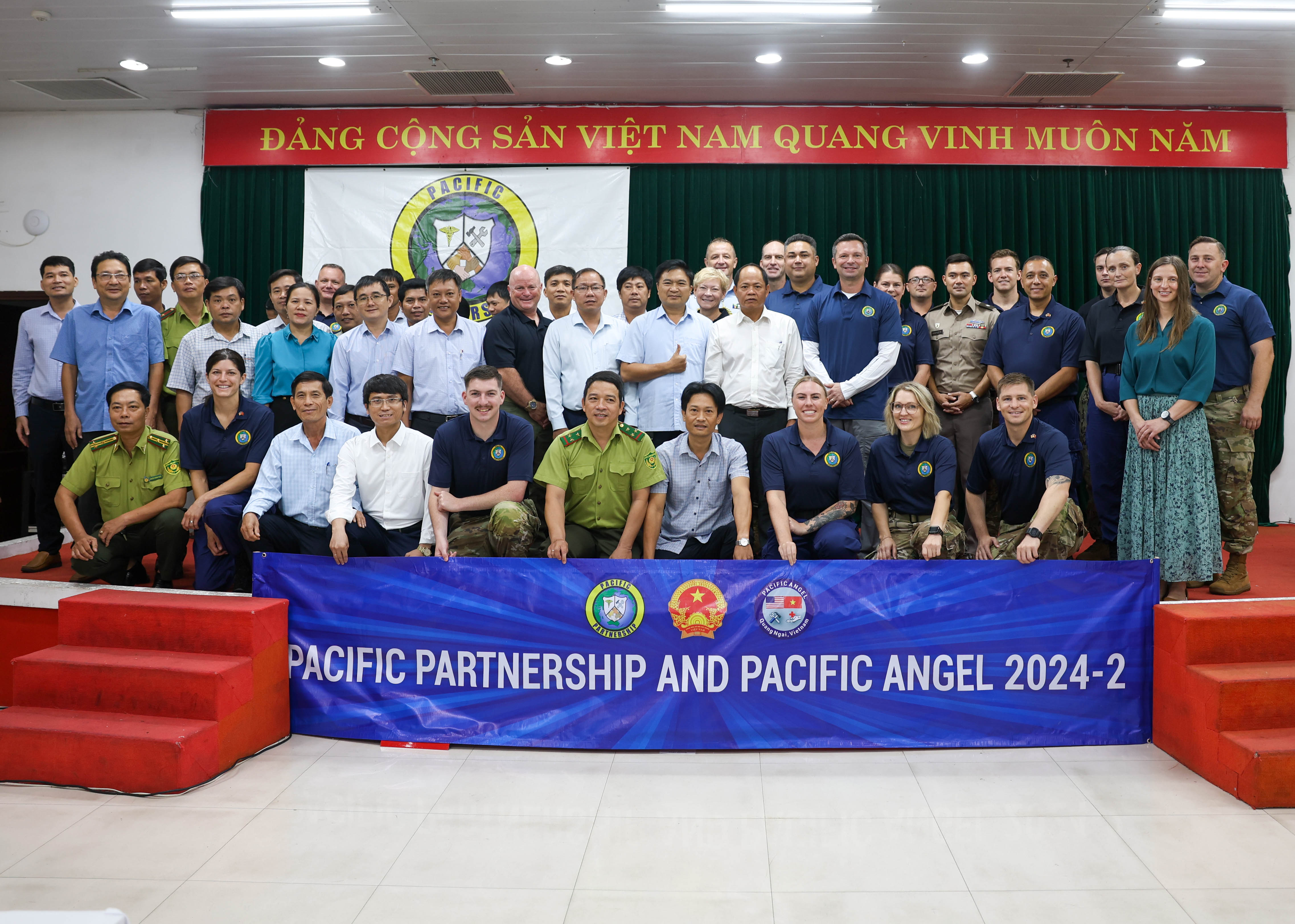 QUANG NGAI, Vietnam (Aug. 20, 2024) - U.S. and partner nation service members with Pacific Partnership 2024-2 and Pacific Angel 2024-3 take a group photo during a Humanitarian Assistance and Disaster Response subject matter expert exchange at Cam Thanh hotel in Quang Ngai, Vietnam, Aug. 20, 2024. Now in its 20th iteration, the Pacific Partnership series is the largest annual multinational humanitarian assistance and disaster relief preparedness mission conducted in the Indo-Pacific. Pacific Partnership works collaboratively with host and partner nations to enhance regional interoperability and disaster response capabilities, increase security and stability in the region, and foster new and enduring friendships in the Indo-Pacific. (U.S. Navy photo by Mass Communication Specialist Seaman Gavin Arnoldhendershot)