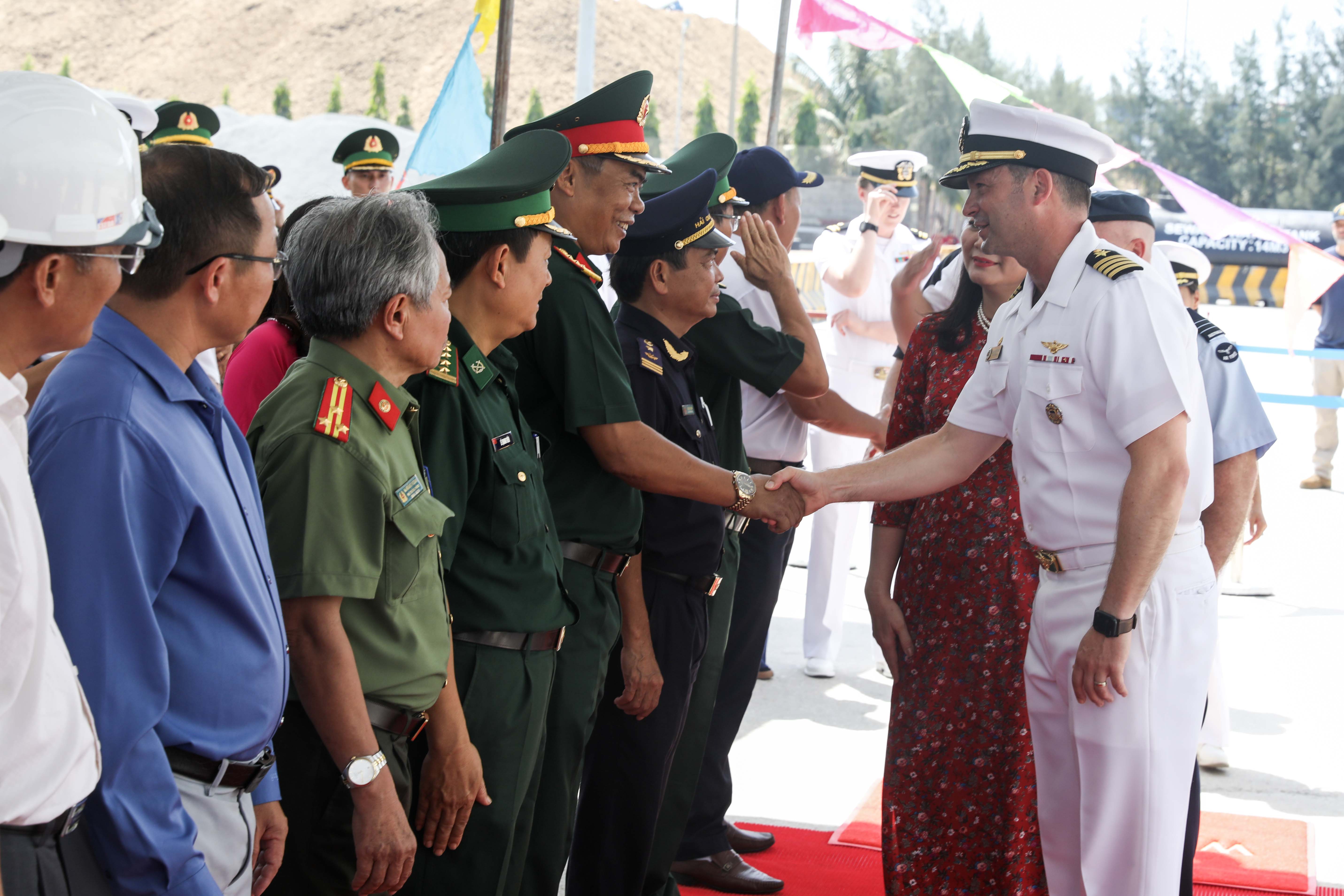 QUANG NGAI, Vietnam (Aug. 19, 2024) - U.S. Navy Capt. Daniel Keeler, Pacific Partnership 2024-2 (PP24-2) mission commander greets members of the Vietnam People’s Armed Forces pier side following the arrival of the expeditionary fast transport ship USNS City of Bismarck (T-EPF 9) and the PP24-2 mission team arrive for the start of Pacific Partnership in Quang Ngai, Vietnam, August 19, 2024. Now in its 20th iteration, the Pacific Partnership series is the largest annual multinational humanitarian assistance and disaster relief preparedness mission conducted in the Indo-Pacific. Pacific Partnership works collaboratively with host and partner nations to enhance regional interoperability and disaster response capabilities, increase security and stability in the region, and foster new and enduring friendships in the Indo-Pacific. (U.S. Navy photo by Mass Communication Specialist 1st Class Ryan D. McLearnon/Released)