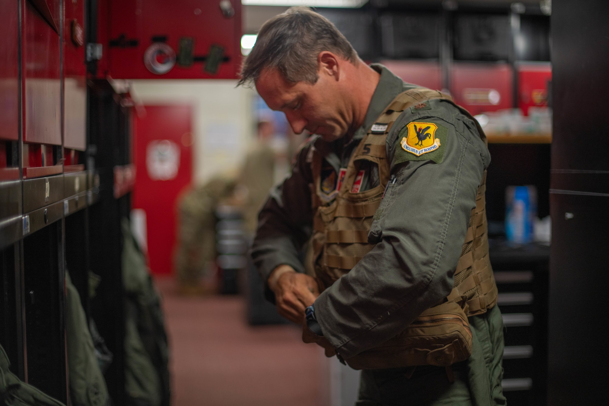 U.S. Air Force Maj. Peter Gawor, 67th Fighter Squadron director of operations, puts on flight gear before F-15C Eagle A5095’s final flight and retirement at Kadena Air Base, Japan, Aug. 15, 2024.