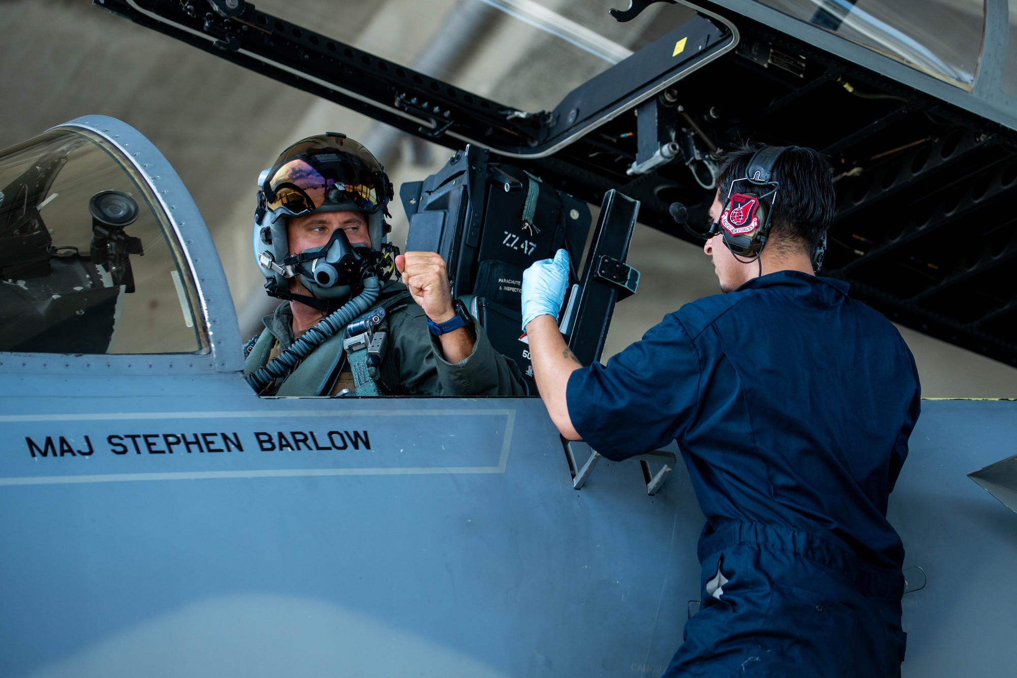 U.S. Air Force Maj. Peter Gawor, left, 67th Fighter Squadron director of operations, fist bumps Senior Airman Nicolas Stillman, 18th Aircraft Maintenance Squadron assistant dedicated crew chief, at Kadena Air Base, Japan, Aug. 15, 2024.