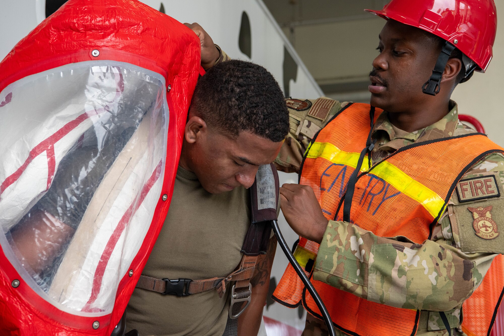 firemen puts on decontamination suit