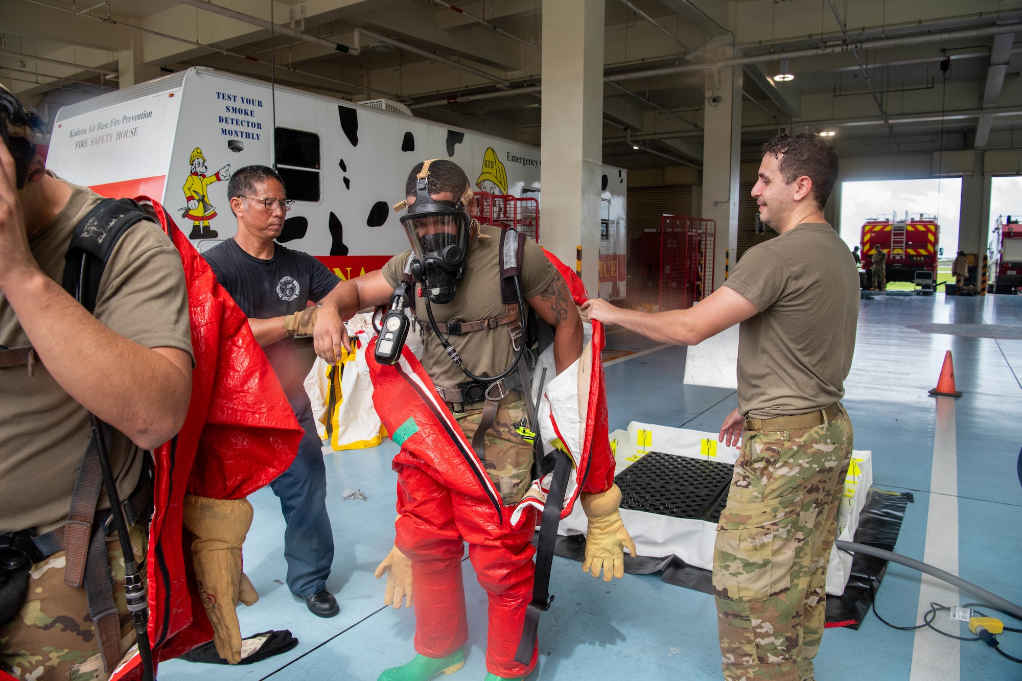 Firemen takes off decontamination suit