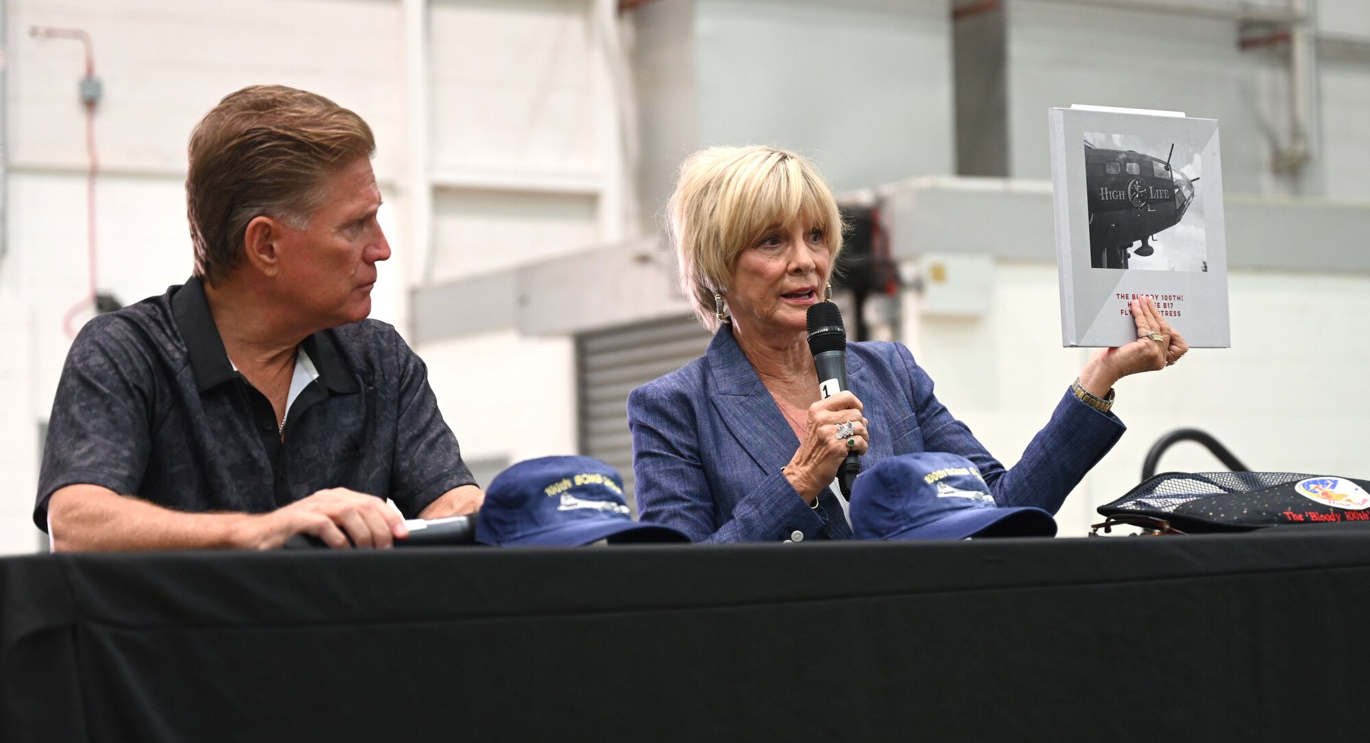 Curtis Wilson, left, son of U.S. Army Air Forces Capt. Charlie “Hong Kong” Wilson, 350th Bomb Squadron pilot, and Paula Harper-Sparks, daughter of U.S. Army Air Forces Flight Officer Joseph Harper, 351st Bomb Squadron and 100th Bomb Group co-pilot, share stories of their fathers’ time flying missions out of Thorpe Abbotts during World War II as part of Heritage Day events at Royal Air Force Mildenhall, England, Aug. 16, 2024. The base welcomed family members of 100th BG veterans who shared stories of their fathers’ time serving during World War II. (U.S. Air Force photo by Karen Abeyasekere)