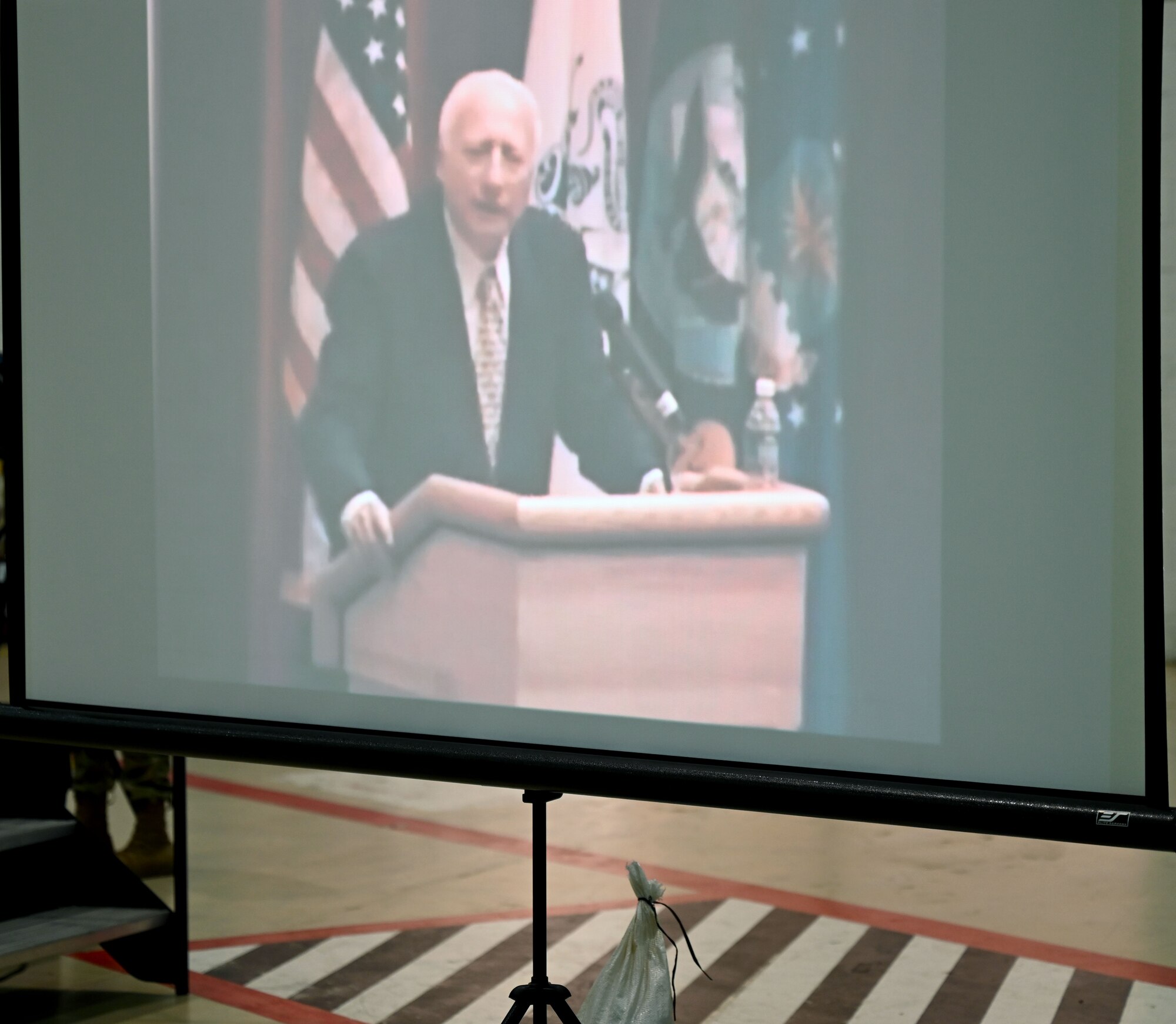A video of retired U.S. Army Air Forces Lt. Col. Robert “Rosie” Rosenthal, renowned 100th Bomb Group pilot who flew 53 missions out of Thorpe Abbotts, England, during World War II, plays during a presentation given by his son Dan Rosenthal, 100th BG Foundation board of directors member, during a presentation about his father at the Heritage Day event at Royal Air Force Mildenhall, England, Aug. 16, 2024. Rosie was one of the main characters featured in the Apple+ mini-series, “Masters of the Air,” which focused on Eighth Air Force and the 100th Bomb Group during World War II, and was highlighted as part of RAF Mildenhall’s Heritage Day celebration. (U.S. Air Force photo by Karen Abeyasekere)