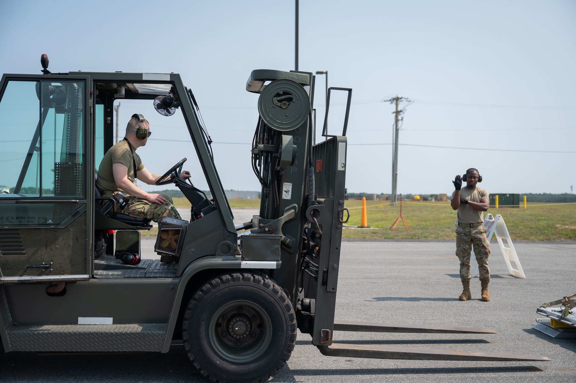 Airmen directs a forklift.