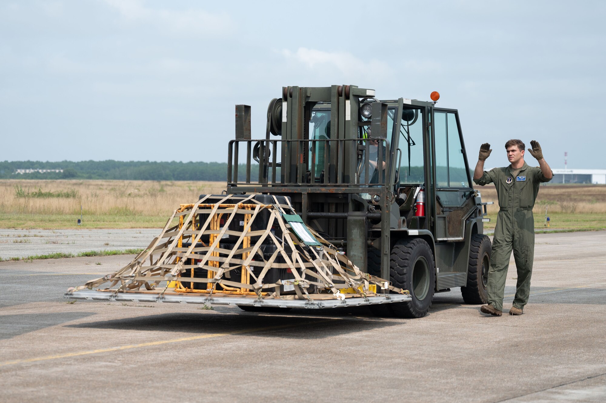 Loadmaster directs a forklift.