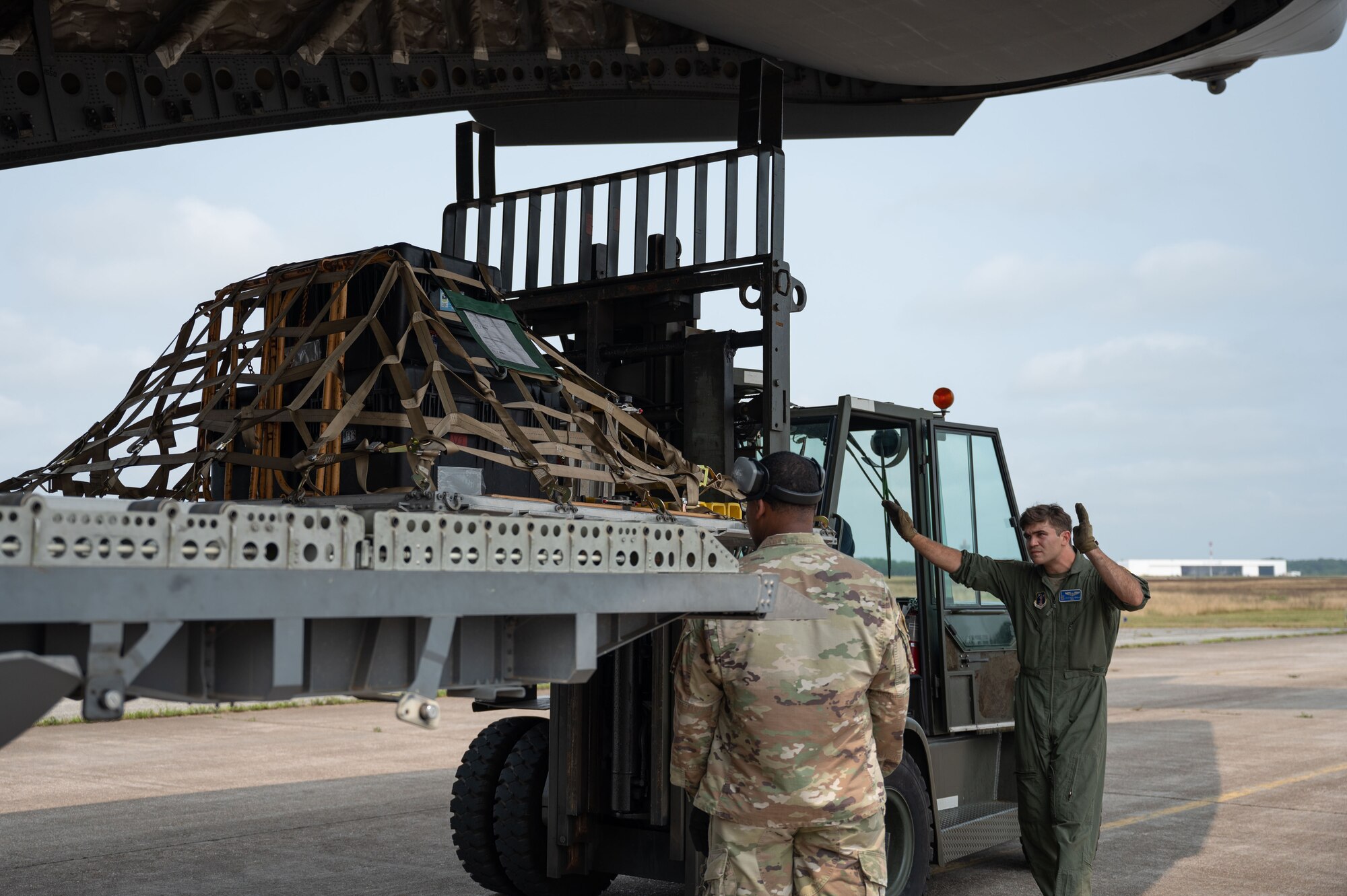 Loadmaster directs a forklift.