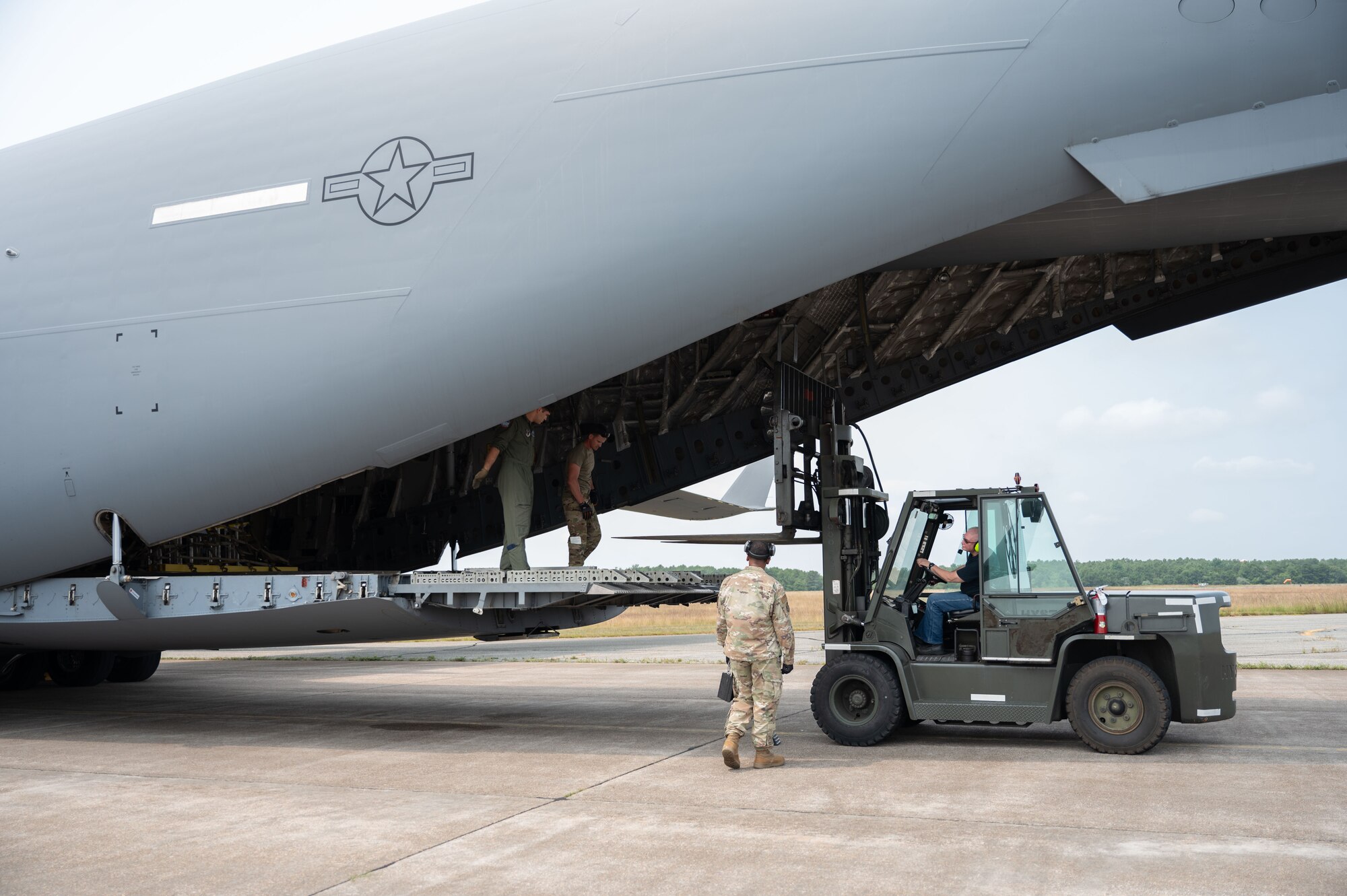 Forklift loads an aircraft.