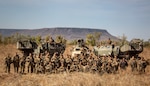Marines pose for a field portrait with their deployable artillery rocket system.