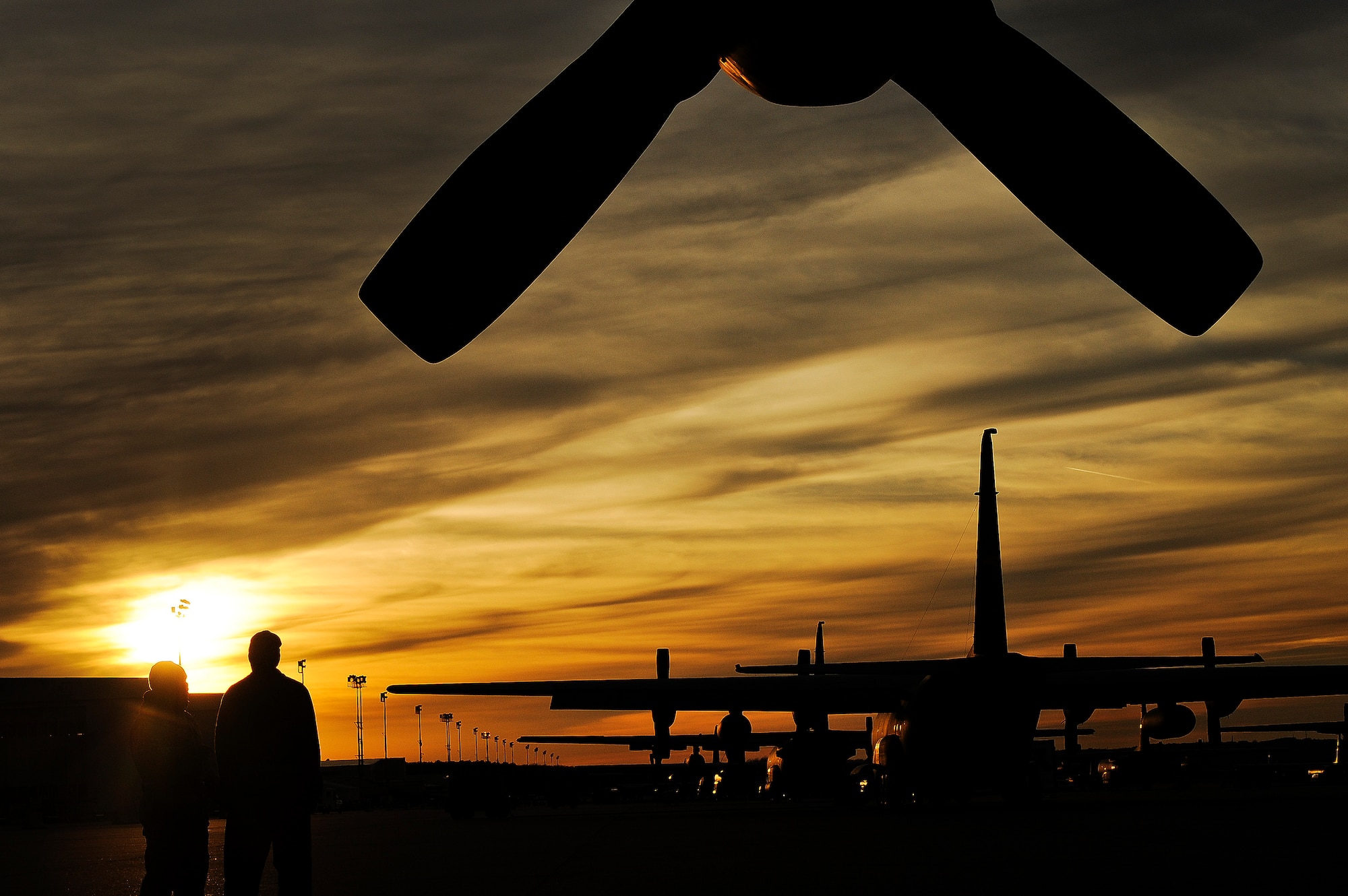 C-130s sit on the flight line.
