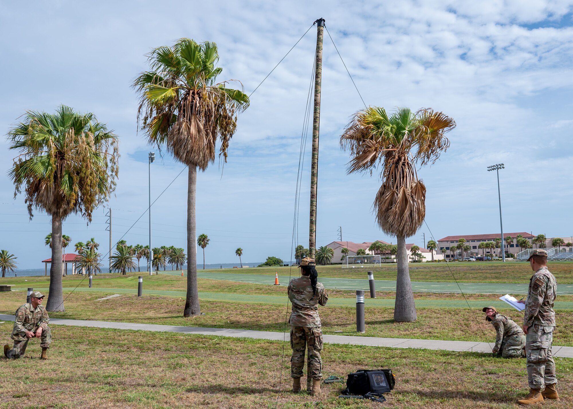 Airmen assigned to the 920th Communications Flight stabilize a rolatube