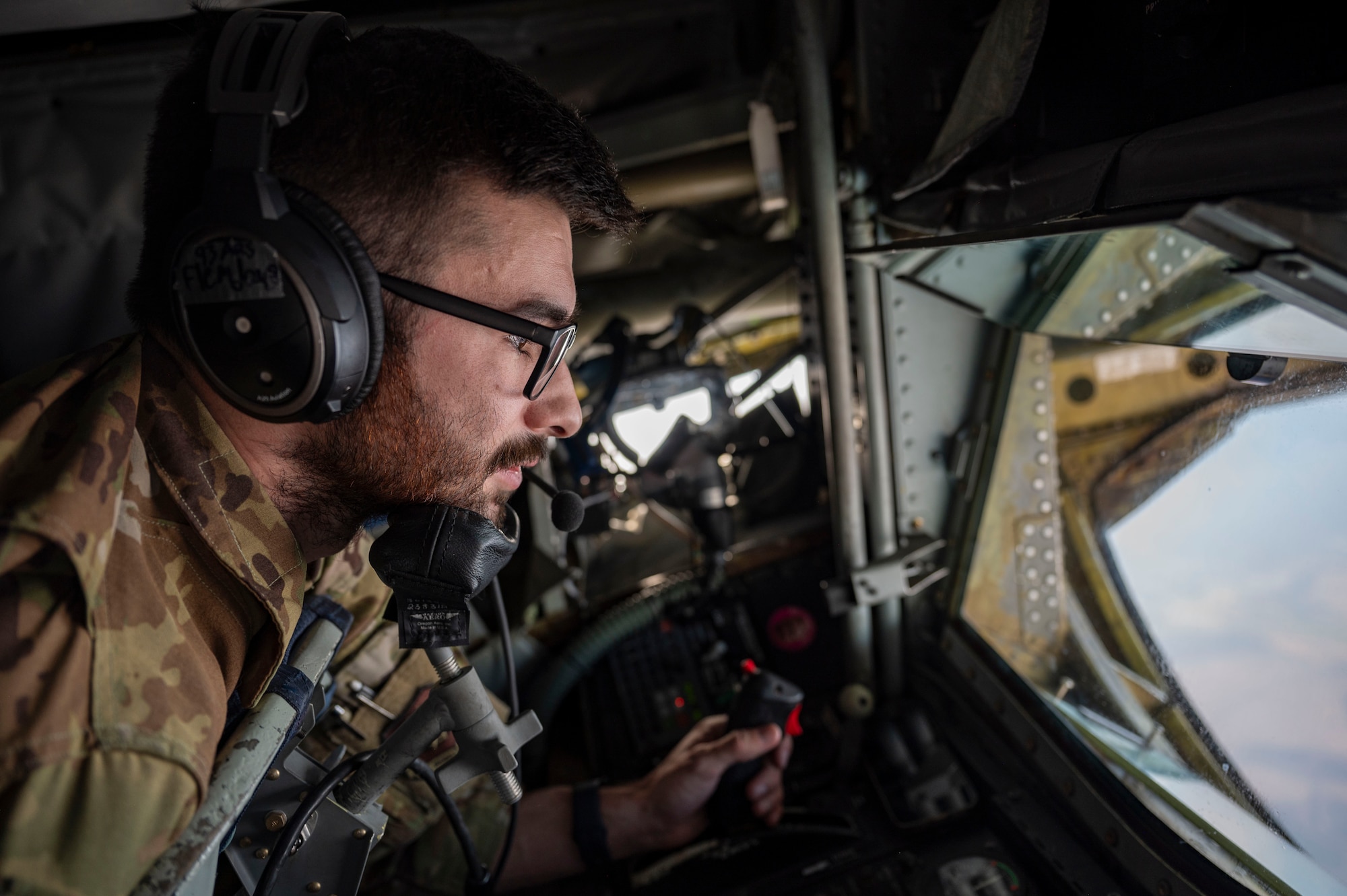 An in-flight refueling specialist lays in the boom pod.