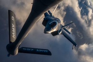 An F-35A Lightning II flies towards a KC-135 Stratotanker.