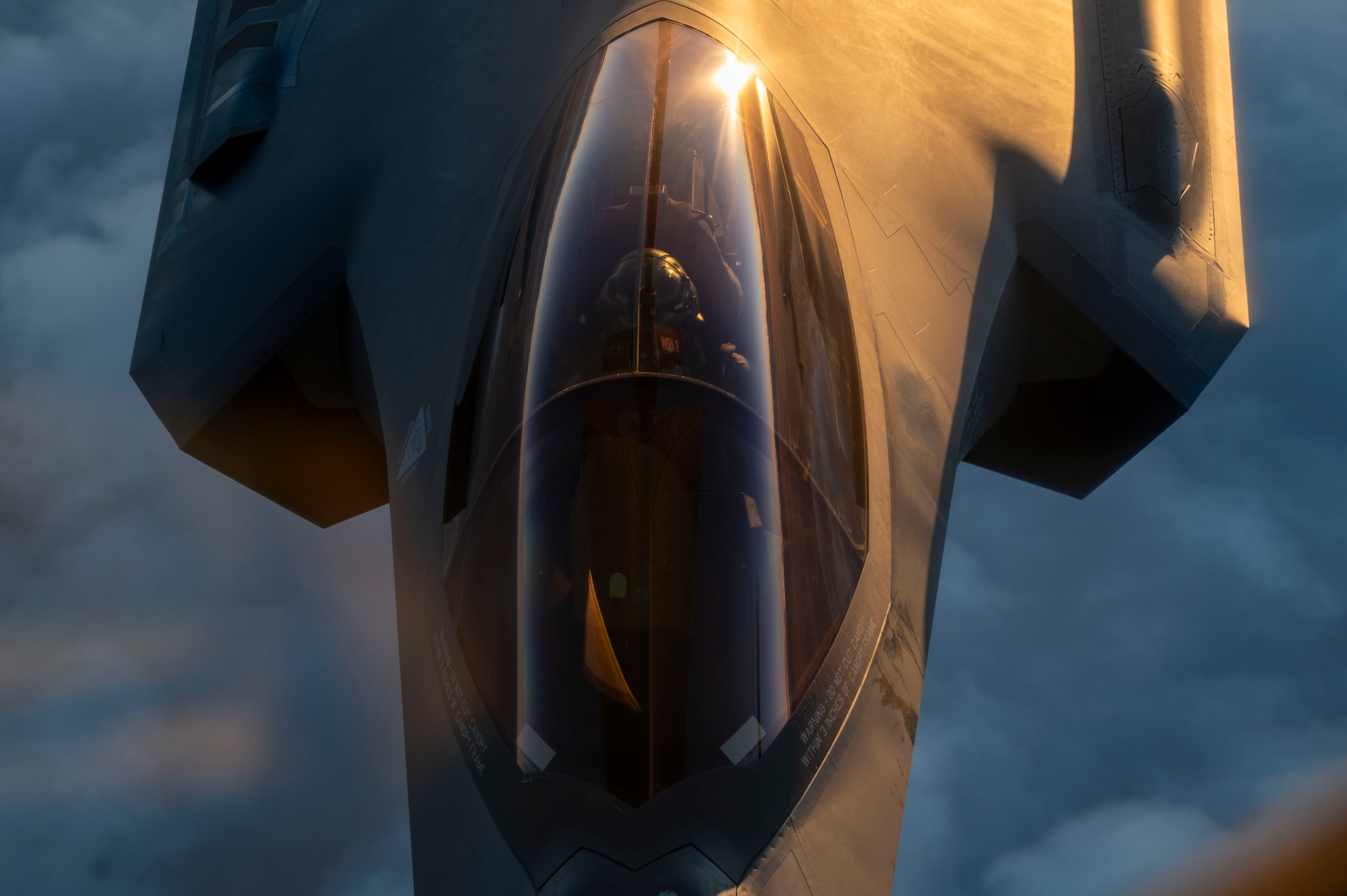 An F-35A Lightning II flies while being refueled.