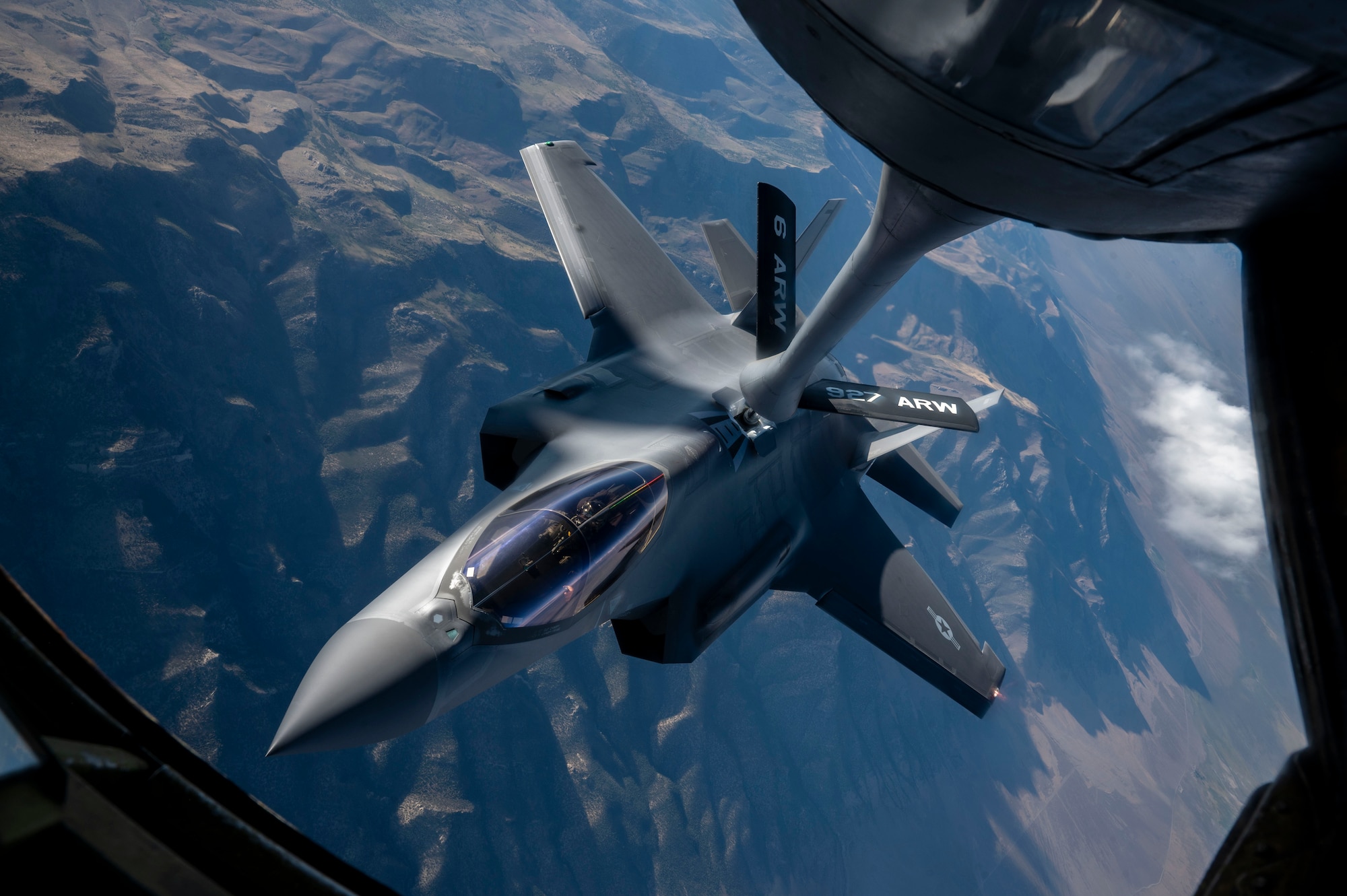 An F-35A Lightning II flies while receiving fuel.