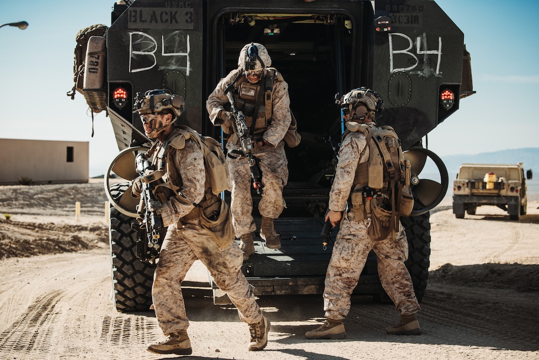 U.S. Marines with 3rd Battalion, 5th Marine Regiment, 1st Marine Division, exit an amphibious combat vehicle during an Adversary Force Exercise as a part of Service-Level Training Exercise 5-24 at Range 220, Marine Corps Air-Ground Combat Center, Twentynine Palms, California, Aug. 6, 2024. SLTE 5-24 is purpose built to train, develop, and validate the Infantry Battalion Experiment as part of a larger Marine Air-Ground Task Force operation as a Stand-in Force across a contested multi-domain distributed environment. (U.S. Marine Corps photo by Cpl. Hunter Wagner)