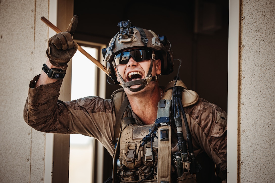 U.S. Marine Corps 1st Lt. John Kelly, infantry officer with 3rd Battalion, 5th Marine Regiment, 1st Marine Division, throws a smoke grenade during an Adversary Force Exercise as part of Service-Level Training Exercise 5-24 at Range 220, Marine Corps Air-Ground Combat Center, Twentynine Palms, California, Aug. 6, 2024. SLTE 5-24 is purpose built to train, develop, and validate the Infantry Battalion Experiment as part of a larger Marine Air-Ground Task Force operation as a Stand-in Force across a contested multi-domain distributed environment. (U.S. Marine Corps photo by Cpl. Hunter Wagner)