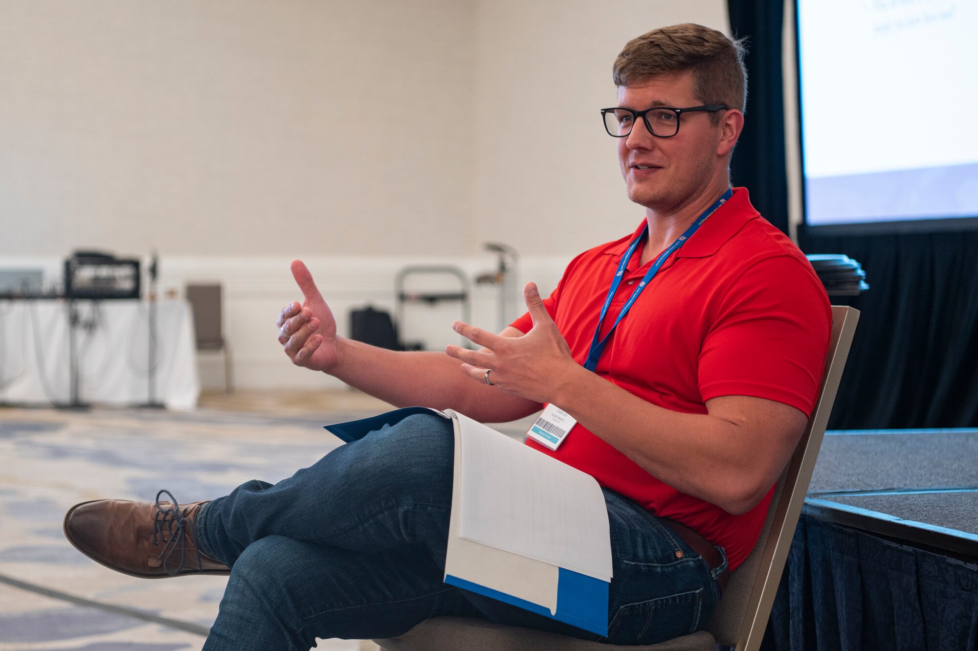Photo of U.S. Air Force Maj. Blake Campbell sitting in a chair speaking.