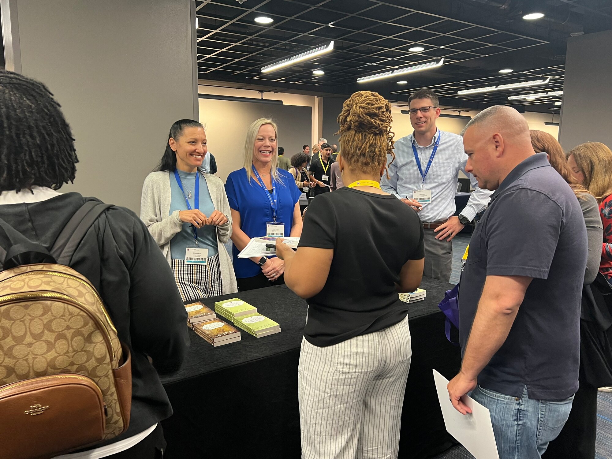 Photo of people standing around a table talking.