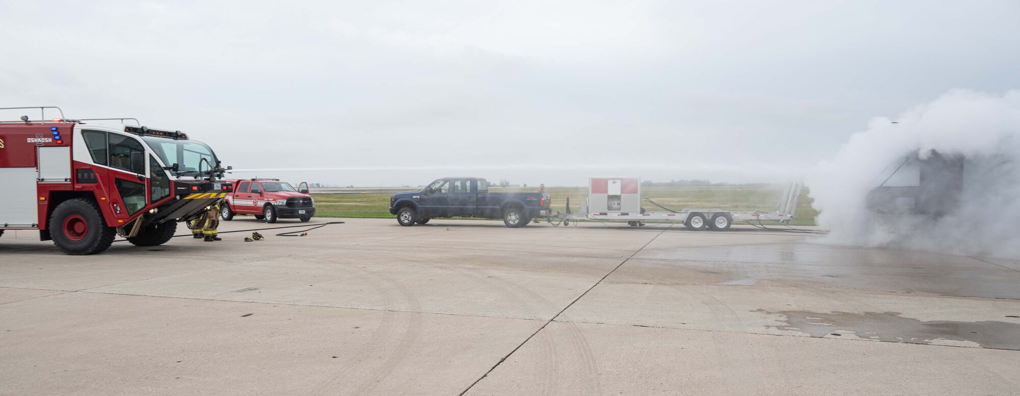 Firefighters assigned to the 5th Civil Engineer Squadron extinguish the simulated wreckage of a helicopter during a major accident response exercise (MARE) at Minot Air Force Base, North Dakota, Aug. 21, 2024. MAREs provide realistic training opportunities for Airmen to enhance response procedures in the event of a real-world incident. (U.S. Air Force photo by Senior Airman Kyle Wilson)