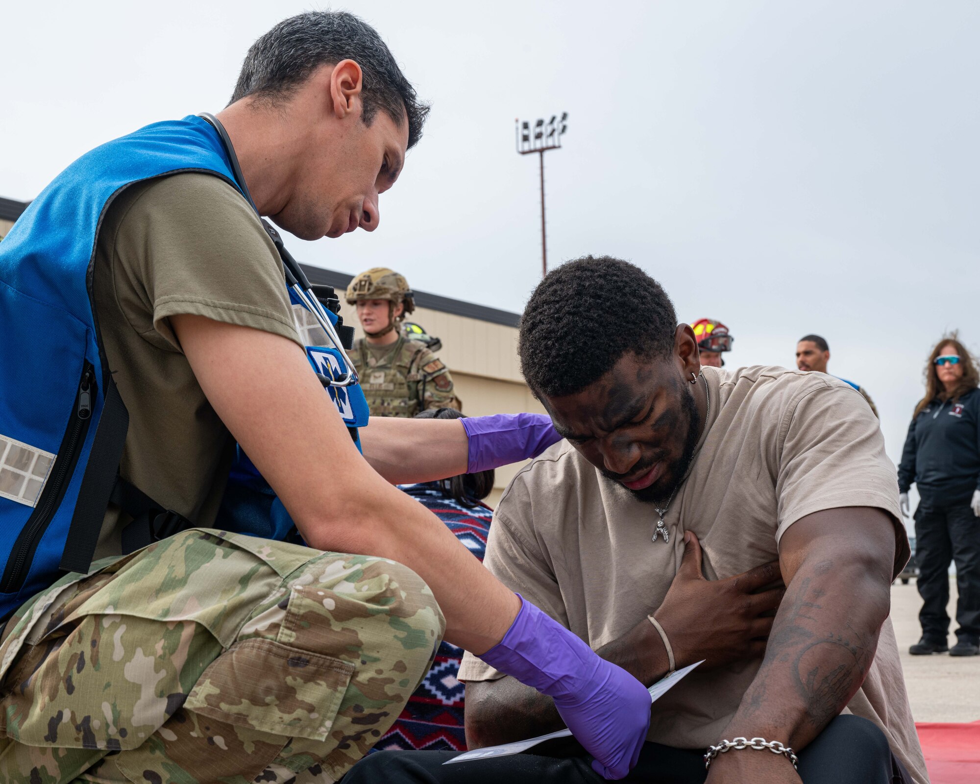 An Airman assigned to the 5th Medical Group tends to a simulated casualty during a major accident response exercise (MARE) at Minot Air Force Base, North Dakota, Aug. 21, 2024. MAREs provide realistic training opportunities for Airmen to enhance response procedures in the event of a real-world incident. (U.S. Air Force photo by Senior Airman Kyle Wilson)