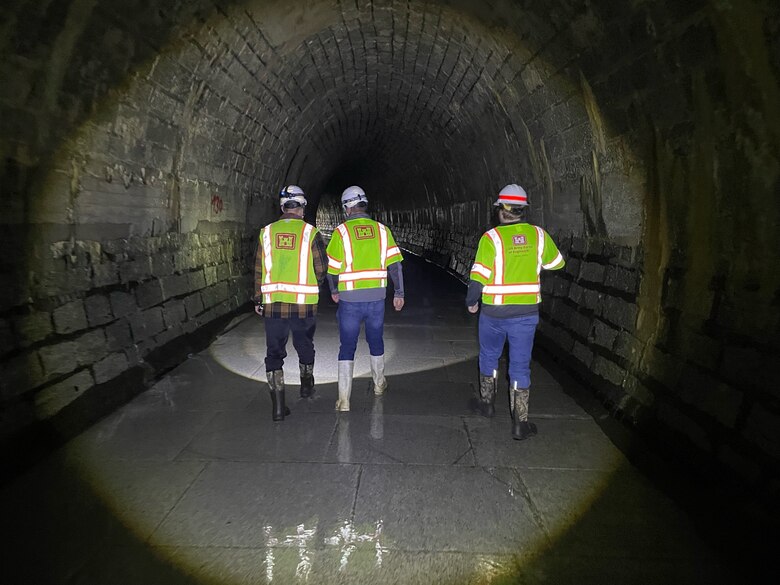 USACE staff investigate the Pfaffensprung sediment bypass tunnel in Switzerland. This critical piece of infrastructure flushes material from the dam’s pool, which can include sediment and larger matter. (Photo by Jesse Brown, USACE – Huntington District)