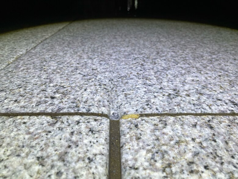 Wear can be seen on granite pavers in the Pfaffensprung tunnel where the movement of particles through water has caused a groove to form in the material. While granite is one of the most durable materials to be used in this role, it is not immune to the forces exerted by flowing sediment particles. Careful repairs and maintenance are required to keep the tunnel fully operational and effective. (Photo by Jesse Brown, USACE – Huntington District)