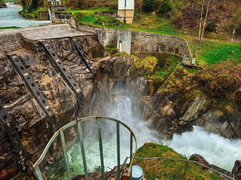 The Pfaffensprung sediment bypass tunnel is visible from above the dam and the outlet. This infrastructure has been in use for over 100 years and continues to provide flood protection and hydropower for the surrounding communities. (Photo by Carly Lynch, USACE – Alaska District)